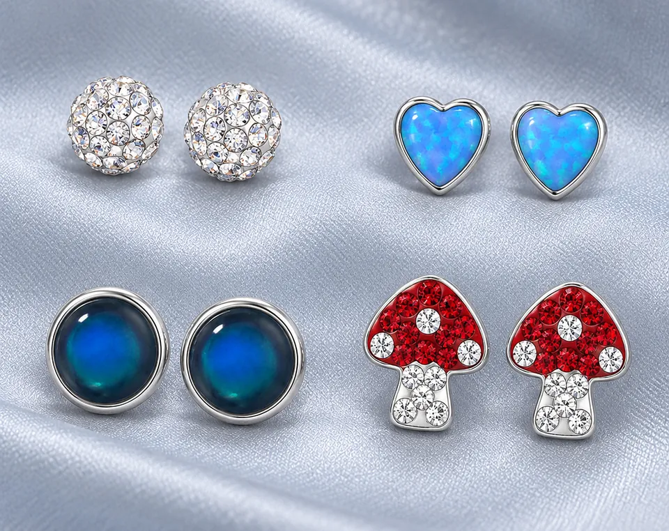 Silver crystal, blue heart and toadstool earrings on satin