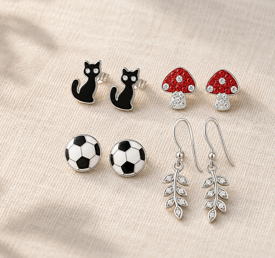 A selection of Zenvie character earrings on naturally lit linen